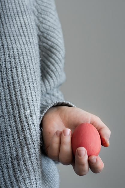 A close-up shot of a person's hand gently holding a stress ball, with a muted, calming color palette. The focus is on the texture of the stress ball and the person's relaxed grip.