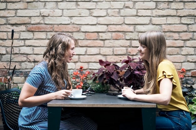 Two friends having an open and honest conversation in a well-lit cafe, symbolizing healthy communication and respect for boundaries.