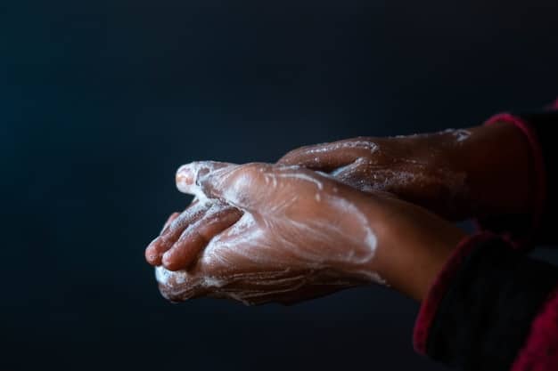 A photo depicting a person thoroughly washing their hands with soap and water, emphasizing the importance of this preventive measure.
