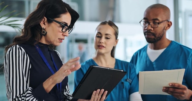 A group of healthcare professionals (doctors, nurses, and medical assistants) working together in a rural clinic. They are reviewing patient charts and discussing treatment plans.