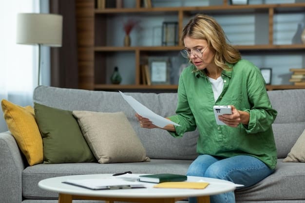 A person filling out an application form for a home energy efficiency grant, with a calculator and energy bill on the desk.