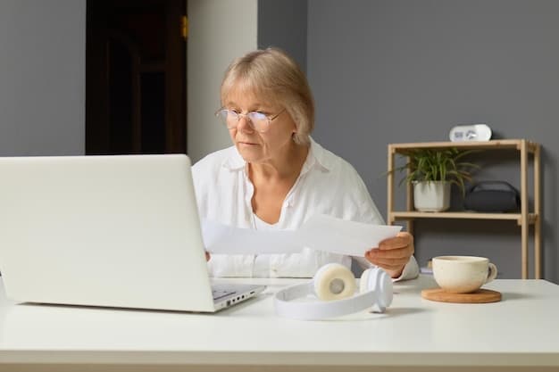 A caregiver reviewing tax documents with a thoughtful expression. The setting is a home office with a laptop and financial papers spread across the desk, highlighting the importance of understanding tax benefits for caregivers.
