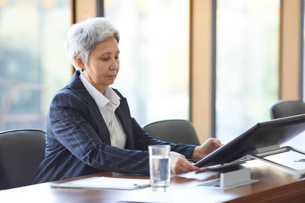 A financial advisor is sitting at a desk, reviewing documents and charts with a middle-aged couple. They are discussing long-term care insurance options as part of the couple's overall financial plan. The scene is professional and collaborative.
