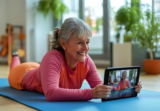 An elderly woman wearing a smartwatch with a clear display of her heart rate and blood pressure. She is smiling and actively engaged in a video call with her doctor on a tablet.