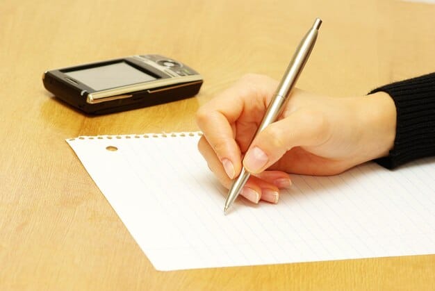 A hand holding a pen, filling out a tax form on a desk cluttered with various documents like W-2s, Social Security cards, and bank statements, illustrating the document preparation needed for claiming the Child Tax Credit.